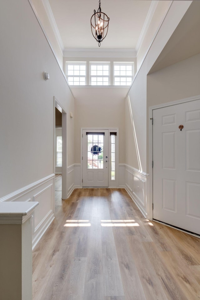 309 Patriotic Way, Mount Juliet, TN 37122 - foyer entrance featuring a chandelier, crown molding, plenty of natural light, a wainscoted wall, and wood finished floors