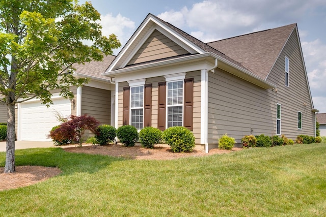 309 Patriotic Way, Mount Juliet, TN 37122 - view of side of home featuring an attached garage, roof with shingles, a lawn, and driveway