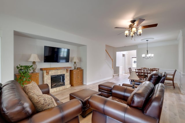 309 Patriotic Way, Mount Juliet, TN 37122 - living room with light wood-type flooring, a ceiling fan, a stone fireplace, stairway, and a chandelier