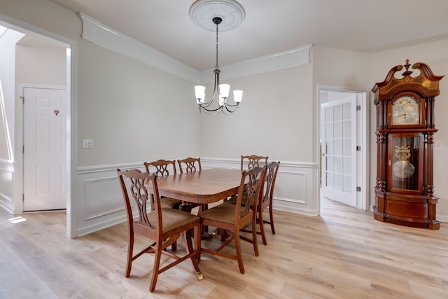 309 Patriotic Way, Mount Juliet, TN 37122 - dining room featuring a chandelier, light wood-style flooring, crown molding, a decorative wall, and wainscoting