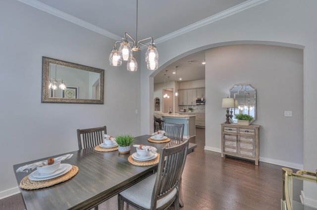1655 Burrows Ave, Murfreesboro, TN 37129 - dining area with arched walkways, dark wood-type flooring, crown molding, and a chandelier