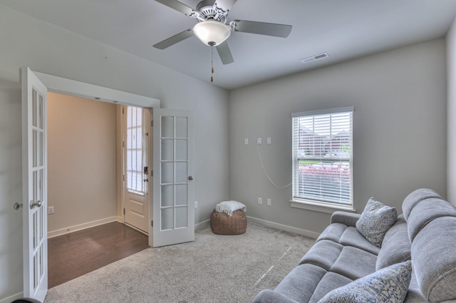 1655 Burrows Ave, Murfreesboro, TN 37129 - living area with dark colored carpet, french doors, and a ceiling fan