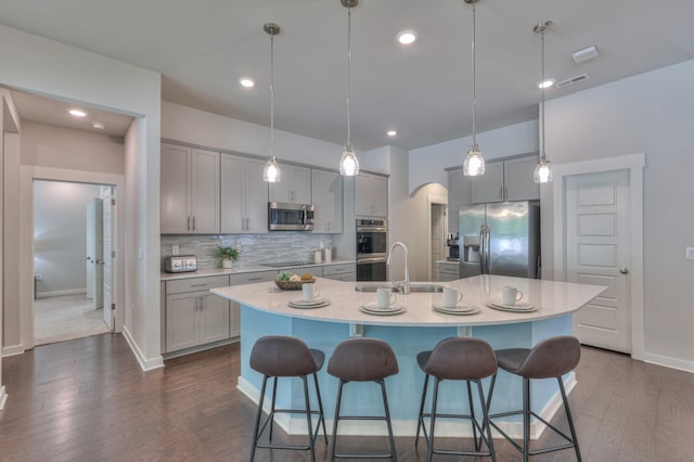1655 Burrows Ave, Murfreesboro, TN 37129 - kitchen featuring stainless steel appliances, gray cabinetry, a kitchen breakfast bar, dark wood-style floors, and recessed lighting