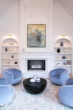 119 Winslow Rd, Franklin, TN 37064 - living area featuring built in shelves, a fireplace with raised hearth, and high vaulted ceiling
