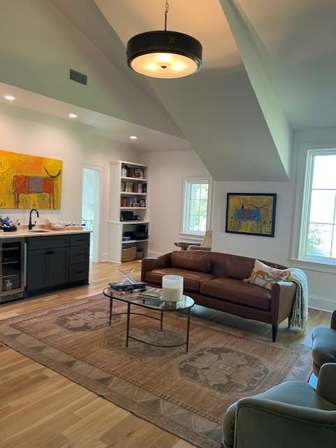 119 Winslow Rd, Franklin, TN 37064 - living area with beverage cooler, light wood-style floors, plenty of natural light, vaulted ceiling, and recessed lighting