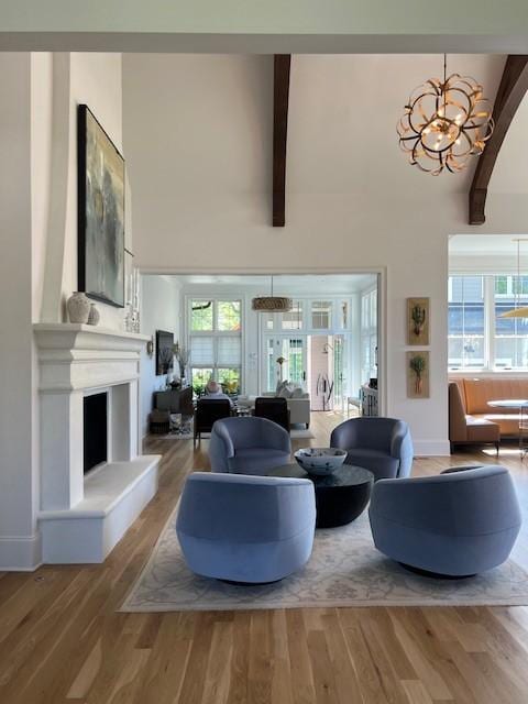 119 Winslow Rd, Franklin, TN 37064 - living room featuring a chandelier, beamed ceiling, wood finished floors, plenty of natural light, and high vaulted ceiling