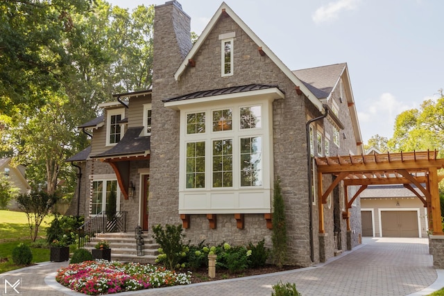119 Winslow Rd, Franklin, TN 37064 - view of front of home featuring stone siding, a chimney, a standing seam roof, decorative driveway, and a shingled roof