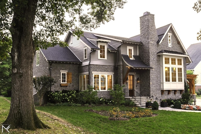 119 Winslow Rd, Franklin, TN 37064 - view of front facade featuring stone siding, a chimney, a front yard, and roof with shingles
