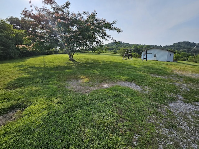 2740 Gladdice Hwy, Whitleyville, TN 38588 - view of green lawn featuring an outbuilding and a mountain view