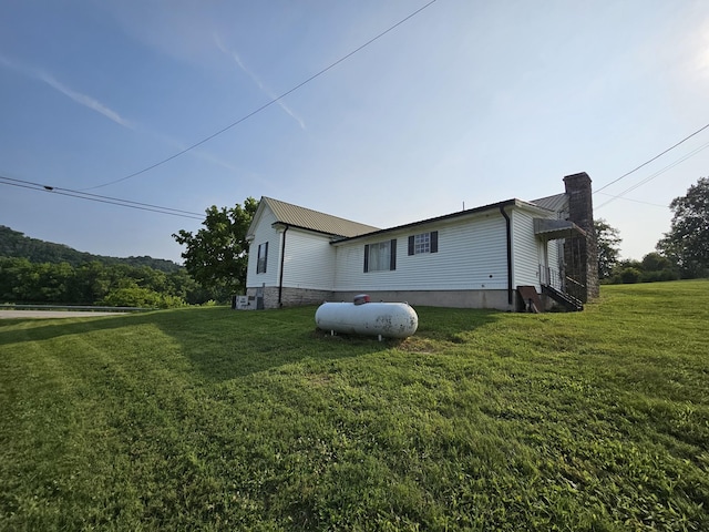2740 Gladdice Hwy, Whitleyville, TN 38588 - view of home's exterior featuring a chimney, a yard, and a metal roof