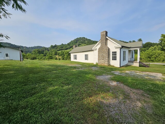 2740 Gladdice Hwy, Whitleyville, TN 38588 - view of property exterior with a chimney and a yard
