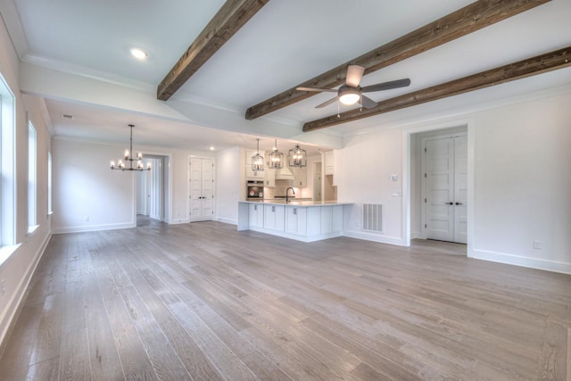 4013 Singing Creek Dr, Franklin, TN 37064 - unfurnished living room featuring a chandelier, ceiling fan, beam ceiling, wood finished floors, and recessed lighting