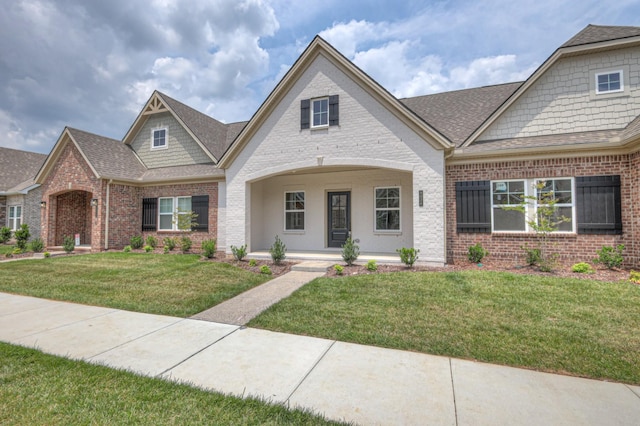 9024 Headwaters Dr Unit 168, Franklin, TN 37064 - view of front of house with brick siding, a front yard, and roof with shingles