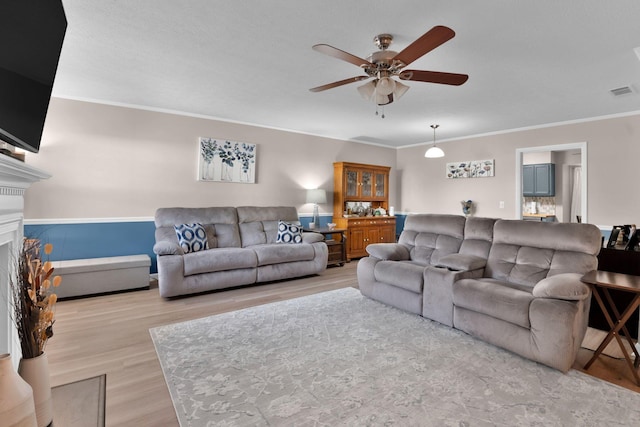 259 Mayflower Ln N, Madison, TN 37115 - living area with a ceiling fan, wood finished floors, crown molding, and a fireplace