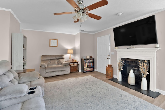 259 Mayflower Ln N, Madison, TN 37115 - living room with ornamental molding, wood finished floors, a ceiling fan, and a glass covered fireplace
