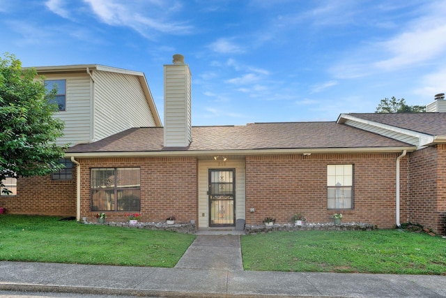 259 Mayflower Ln N, Madison, TN 37115 - view of front of house featuring a chimney, a front yard, and brick siding