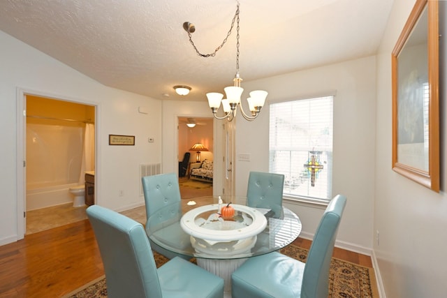 395 Devon Chase Hl Unit 3602, Gallatin, TN 37066 - dining area featuring a chandelier, wood finished floors, and a textured ceiling