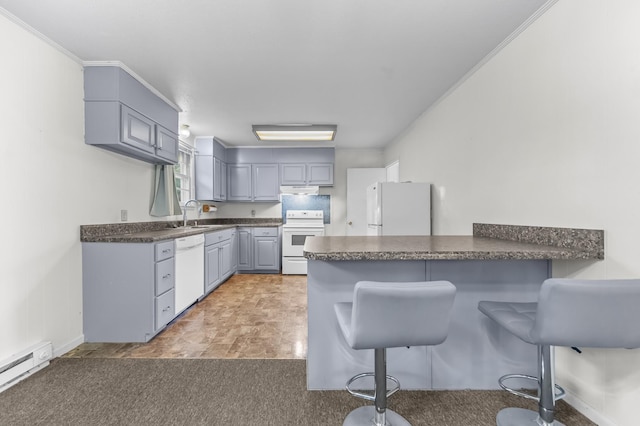 3892 Cedar St, Centerville, TN 37033 - kitchen with white appliances, dark countertops, a peninsula, gray cabinetry, and a baseboard radiator