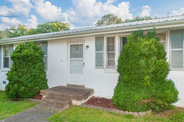 3892 Cedar St, Centerville, TN 37033 - doorway to property featuring brick siding and a metal roof