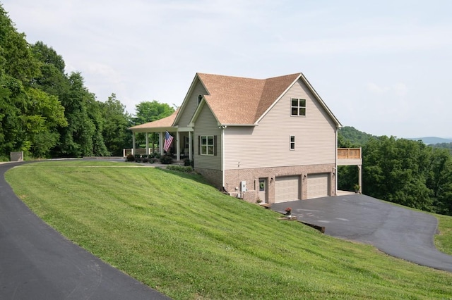 1250 Ed Seay Gregory Ln, Hartsville, TN 37074 - view of property exterior featuring asphalt driveway, an attached garage, a yard, and brick siding