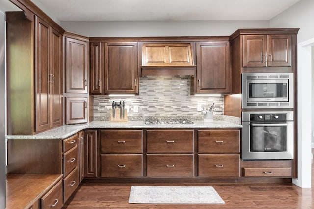 1250 Ed Seay Gregory Ln, Hartsville, TN 37074 - kitchen with stainless steel appliances, dark wood-style floors, backsplash, and light stone counters