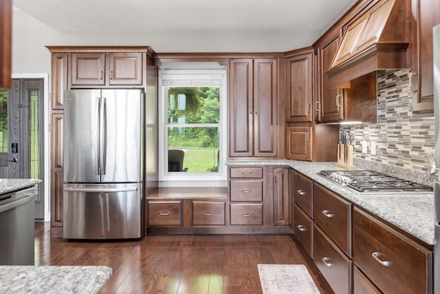 1250 Ed Seay Gregory Ln, Hartsville, TN 37074 - kitchen featuring stainless steel appliances, custom exhaust hood, dark wood-type flooring, backsplash, and light stone countertops