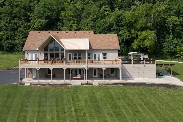 1250 Ed Seay Gregory Ln, Hartsville, TN 37074 - rear view of house featuring a patio, a wooden deck, a lawn, and french doors