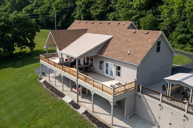 1250 Ed Seay Gregory Ln, Hartsville, TN 37074 - back of house featuring a shingled roof, a wooden deck, a lawn, and a patio area