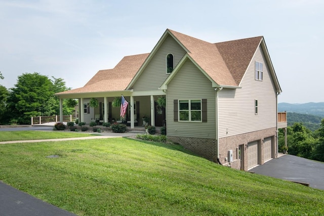 1250 Ed Seay Gregory Ln, Hartsville, TN 37074 - view of front of house featuring asphalt driveway, covered porch, a front lawn, a garage, and roof with shingles