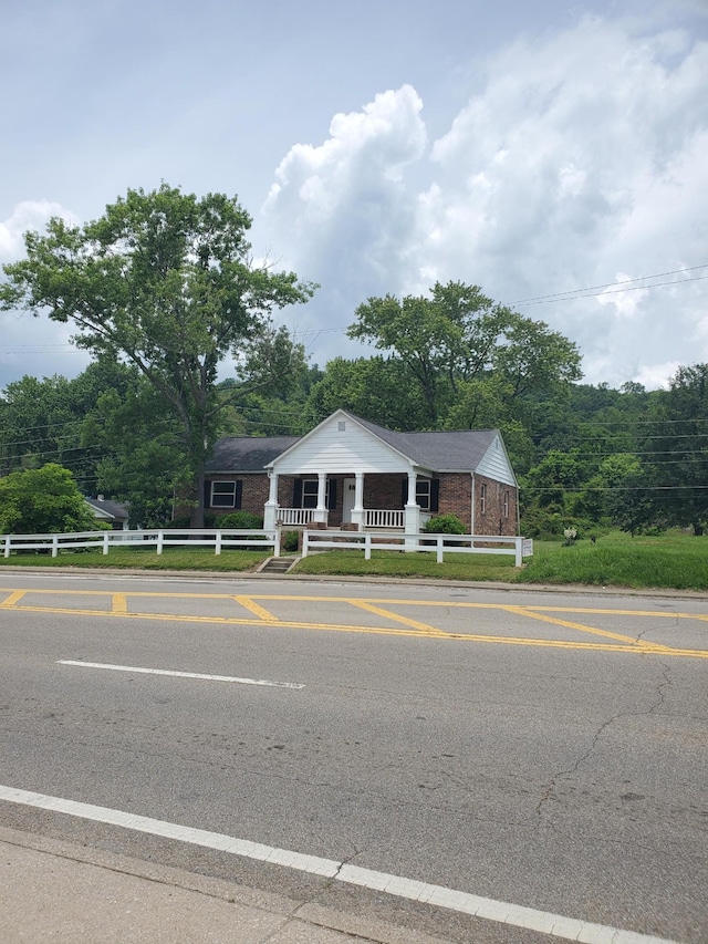 1171 5th St, Jellico, TN 37762 - view of front of house featuring covered porch and brick siding