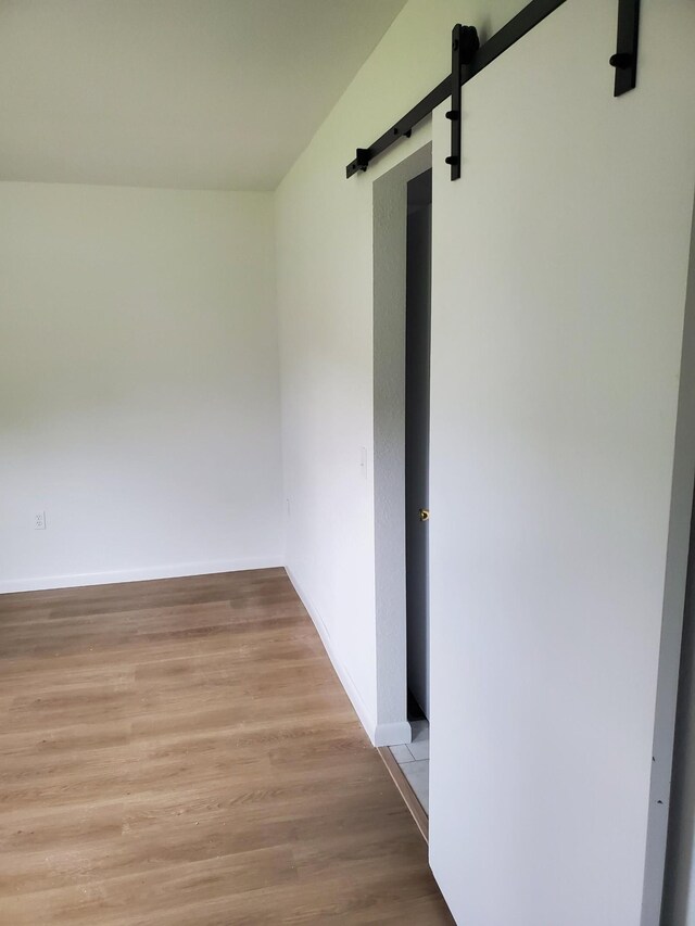 1171 5th St, Jellico, TN 37762 - spare room featuring a barn door and wood finished floors