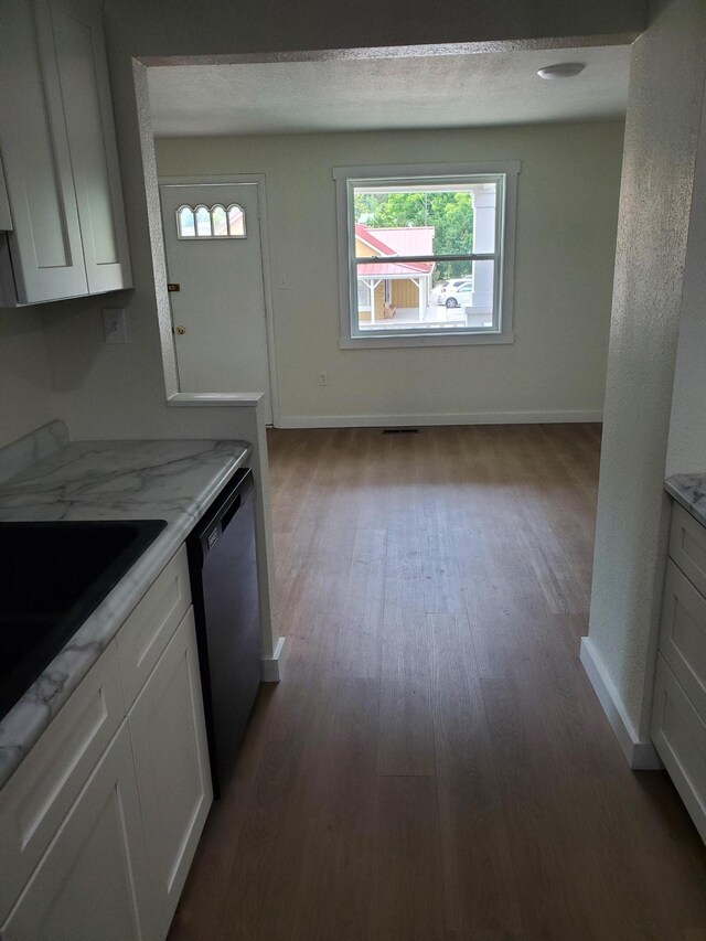 1171 5th St, Jellico, TN 37762 - kitchen featuring dishwasher, wood finished floors, white cabinets, and light stone counters