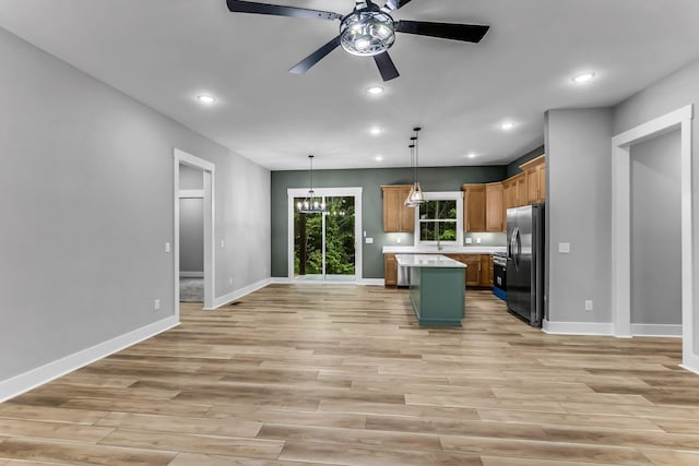 4106 Asbury Rd, Manchester, TN 37355 - kitchen featuring fridge with ice dispenser, light countertops, a kitchen island, light wood-type flooring, and ceiling fan