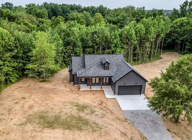4106 Asbury Rd, Manchester, TN 37355 - view of front of property with a porch, driveway, board and batten siding, and a garage