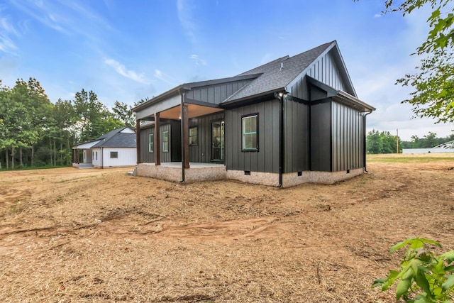 4106 Asbury Rd, Manchester, TN 37355 - view of side of home with board and batten siding, crawl space, a shingled roof, and a patio area