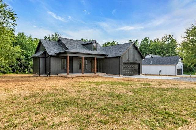 4106 Asbury Rd, Manchester, TN 37355 - modern farmhouse with covered porch, driveway, a front lawn, an attached garage, and a shingled roof