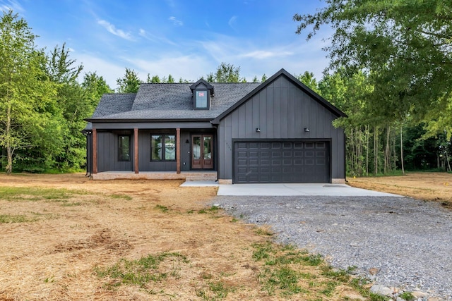 4106 Asbury Rd, Manchester, TN 37355 - modern farmhouse with gravel driveway, an attached garage, a shingled roof, covered porch, and french doors