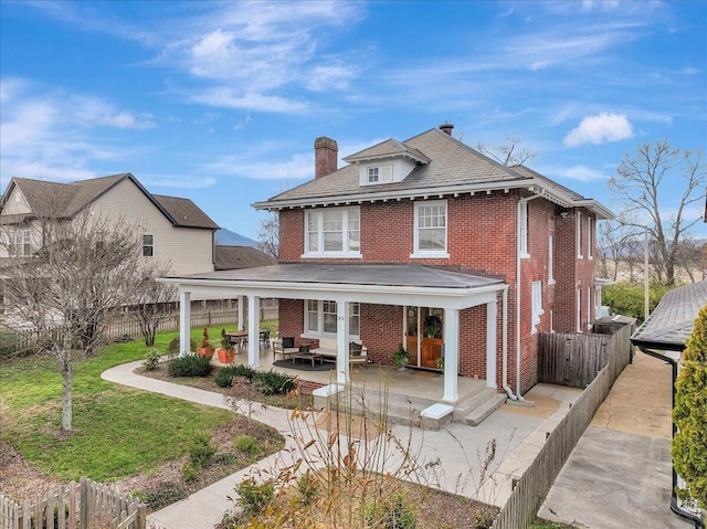 709 S Greenwood Ave S, Chattanooga, TN 37404 - view of front of house featuring a chimney, brick siding, a patio, and a fenced backyard