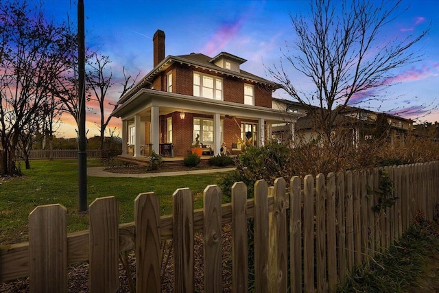 709 S Greenwood Ave S, Chattanooga, TN 37404 - view of front of home featuring brick siding, covered porch, a fenced front yard, and a chimney
