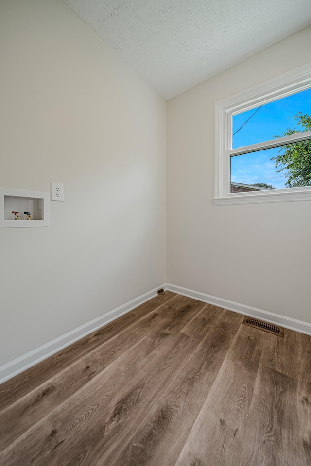 205 Walnut St, Smyrna, TN 37167 - laundry area featuring washer hookup, wood finished floors, and a textured ceiling