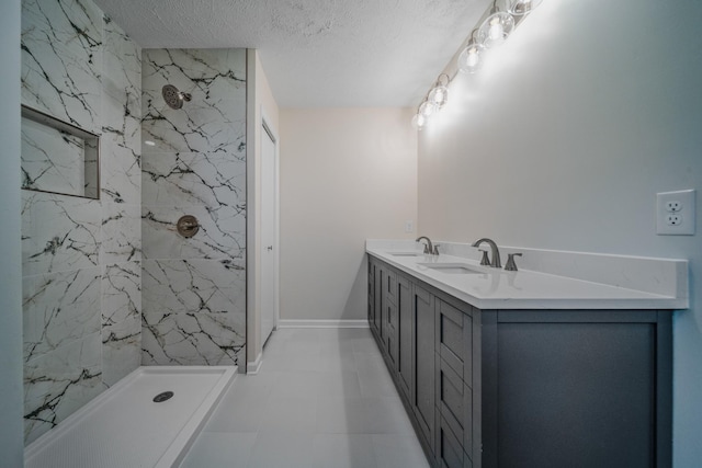 205 Walnut St, Smyrna, TN 37167 - bathroom featuring a marble finish shower, a textured ceiling, and double vanity