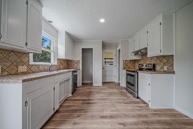 205 Walnut St, Smyrna, TN 37167 - kitchen with stainless steel appliances, under cabinet range hood, a textured ceiling, white cabinets, and light wood-style flooring