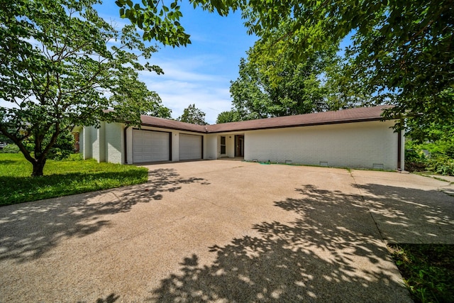 205 Walnut St, Smyrna, TN 37167 - mid-century home featuring a garage, brick siding, concrete driveway, and crawl space