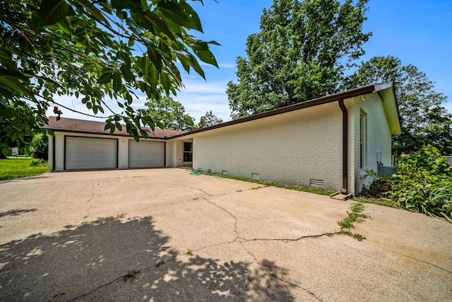 205 Walnut St, Smyrna, TN 37167 - view of front of property featuring crawl space, brick siding, concrete driveway, and an attached garage