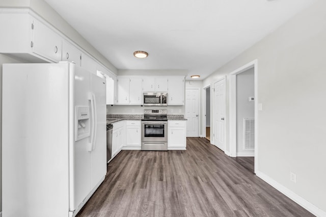 3405 Polly Dr, Clarksville, TN 37042 - kitchen with appliances with stainless steel finishes, dark wood-type flooring, white cabinetry, and stone counters