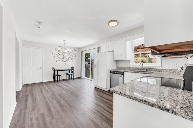 3405 Polly Dr, Clarksville, TN 37042 - kitchen featuring stainless steel dishwasher, white refrigerator with ice dispenser, a chandelier, dark wood finished floors, and plenty of natural light