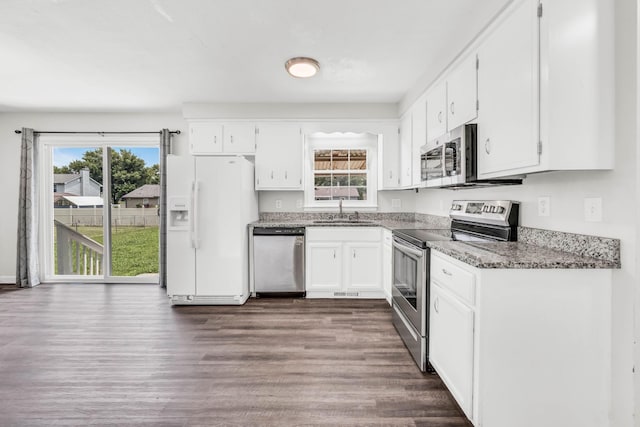 3405 Polly Dr, Clarksville, TN 37042 - kitchen with appliances with stainless steel finishes, dark wood-type flooring, white cabinets, and light stone countertops