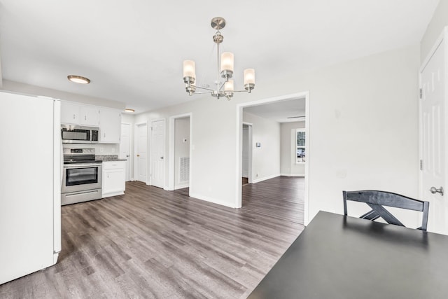 3405 Polly Dr, Clarksville, TN 37042 - kitchen featuring appliances with stainless steel finishes, a chandelier, white cabinets, and wood finished floors
