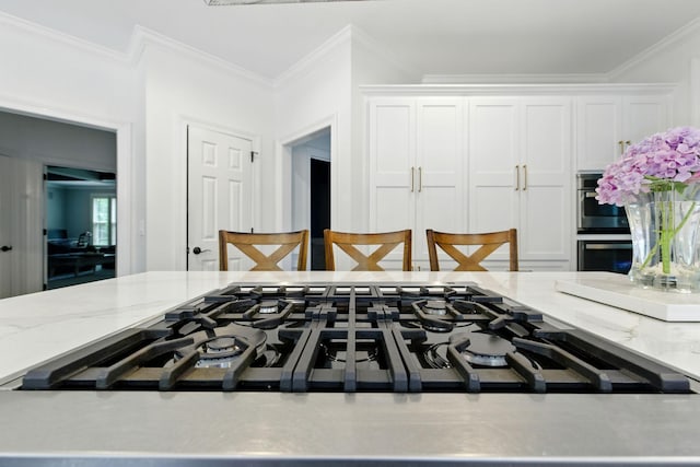 1060 Wilshire Way, Brentwood, TN 37027 - detailed view of stainless steel appliances, white cabinetry, light stone countertops, and ornamental molding