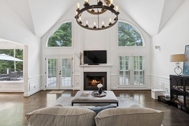 1060 Wilshire Way, Brentwood, TN 37027 - living area featuring plenty of natural light, a chandelier, wainscoting, a lit fireplace, and high vaulted ceiling